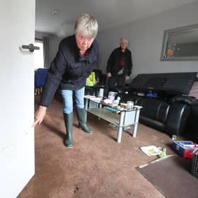 Jean Hendrie and William Craik cleaning their house in Pyothall Court in Broxburn, West Lothian after flooding.