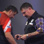 Gary Anderson, right, was unimpressed with opponent Mensur Suljović's pace of play. Picture: Luke Walker/Getty Images
