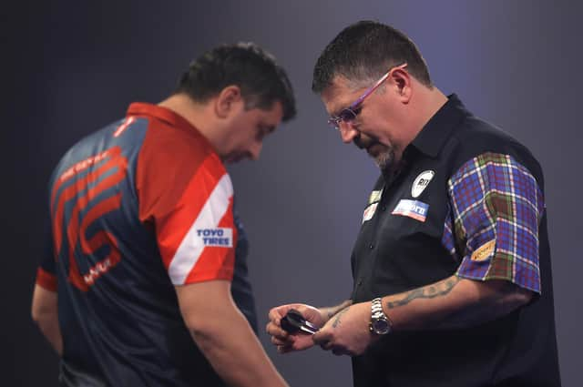 Gary Anderson, right, was unimpressed with opponent Mensur Suljović's pace of play. Picture: Luke Walker/Getty Images