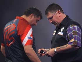 Gary Anderson, right, was unimpressed with opponent Mensur Suljović's pace of play. Picture: Luke Walker/Getty Images