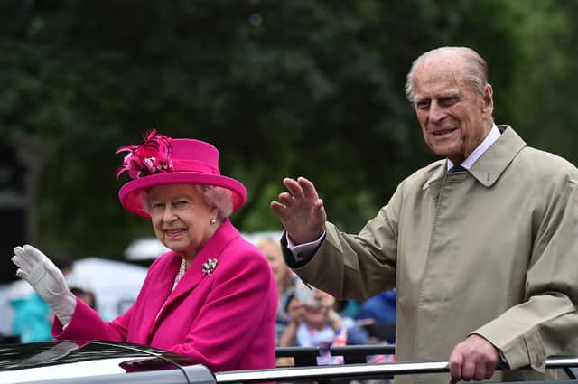 The Queen and Prince Philip pictured waving to guests at a street party outside Buckingham Palace in 2016 (Picture: Getty Images).