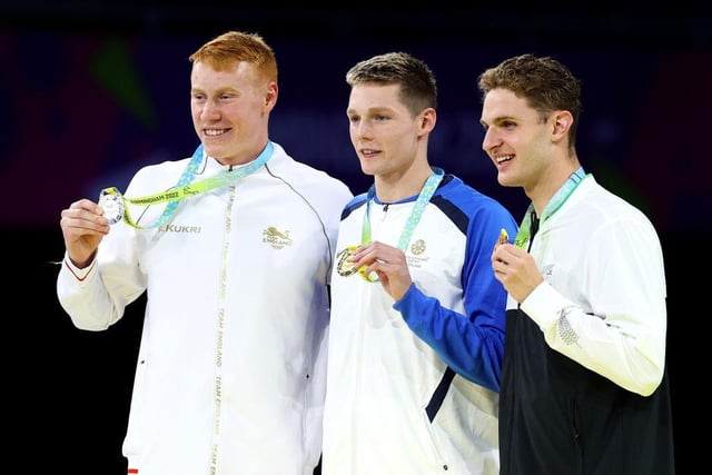 Scottish swimmer Duncan Scott receives his gold medal in the Men's 200m Individual Medley alongside silver medalist, Tom Dean of England and bronze medalist, Lewis Clareburt of New Zealand.