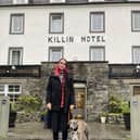 Anfisa Ihnatova, 19, with her dog, Layla, outside their new home at the Killin Hotel. PIC: Contributed.