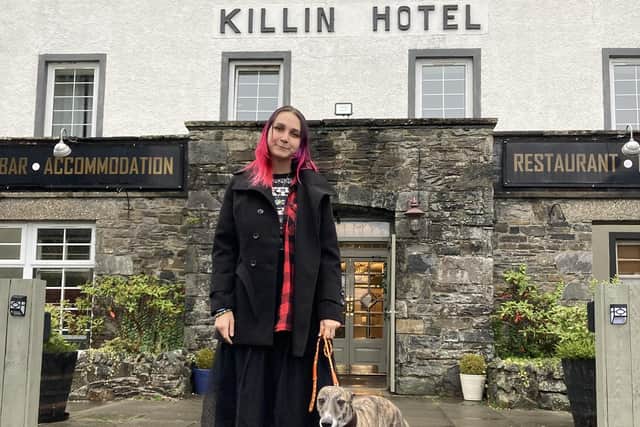 Anfisa Ihnatova, 19, with her dog, Layla, outside their new home at the Killin Hotel. PIC: Contributed.