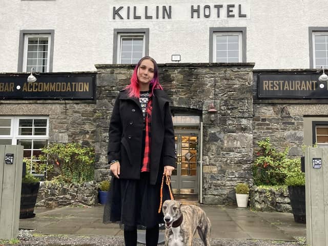 Anfisa Ihnatova, 19, with her dog, Layla, outside their new home at the Killin Hotel. PIC: Contributed.