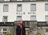 Anfisa Ihnatova, 19, with her dog, Layla, outside their new home at the Killin Hotel. PIC: Contributed.