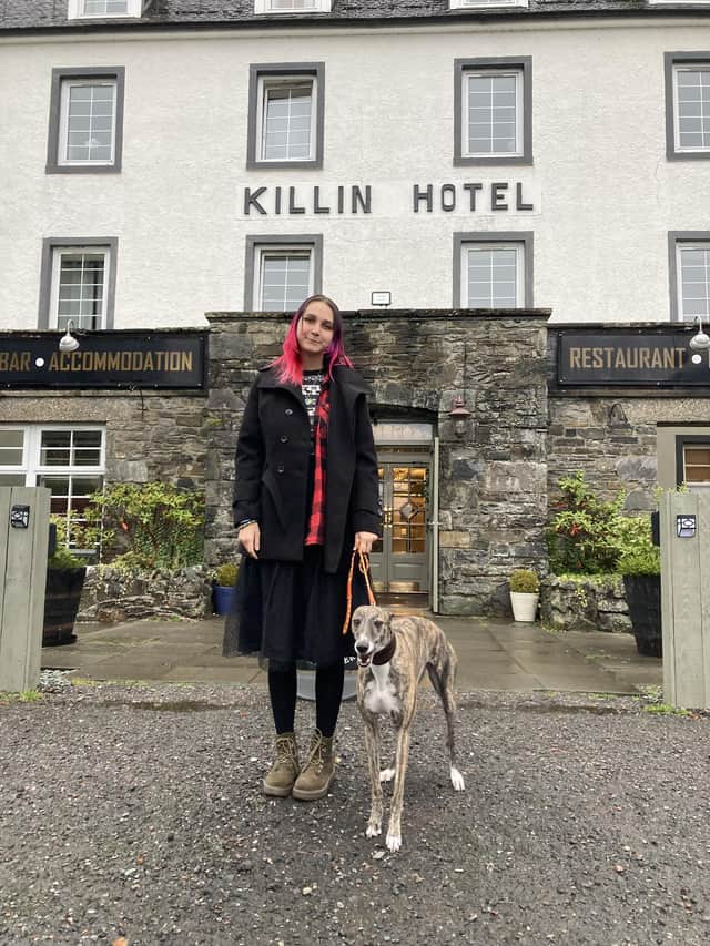 Anfisa Ihnatova, 19, with her dog, Layla, outside their new home at the Killin Hotel. PIC: Contributed.