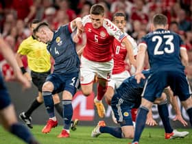 Billy Gilmour (left) tussles with Denmark's Joakim Mahle on a difficult night for Scotland in Copenhagen. (Photo by MADS CLAUS RASMUSSEN/Ritzau Scanpix/AFP via Getty Images)