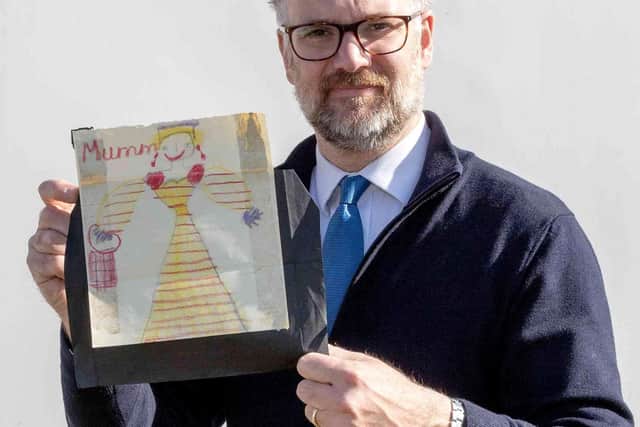 Charles Hanson, owner of Hansons Auctioneers, with a childhood drawing of Queen Elizabeth II drawn by a very young King Charles. Picture: Hansons/SWNS