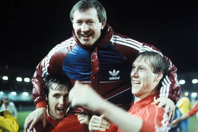 Aberdeen Boss Alex Ferguson is held high by his players.