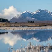 The snow-covered peak of Beinn Eighe and the mountains of Torridon are reflected in Loch Droma near Ullapool, Wester Ross. Jane Barlow/PA Wire