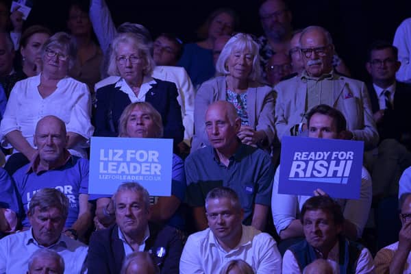 Audience members hold placards showing support for each candidate, on August 01, 2022 in Exeter, England. Conservative Party Leadership hopefuls Liz Truss and Rishi Sunak will attend the second party membership hustings in Exeter this evening.  (Photo by Finnbarr Webster/Getty Images)