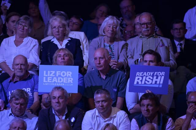 Audience members hold placards showing support for each candidate, on August 01, 2022 in Exeter, England. Conservative Party Leadership hopefuls Liz Truss and Rishi Sunak will attend the second party membership hustings in Exeter this evening. (Photo by Finnbarr Webster/Getty Images)