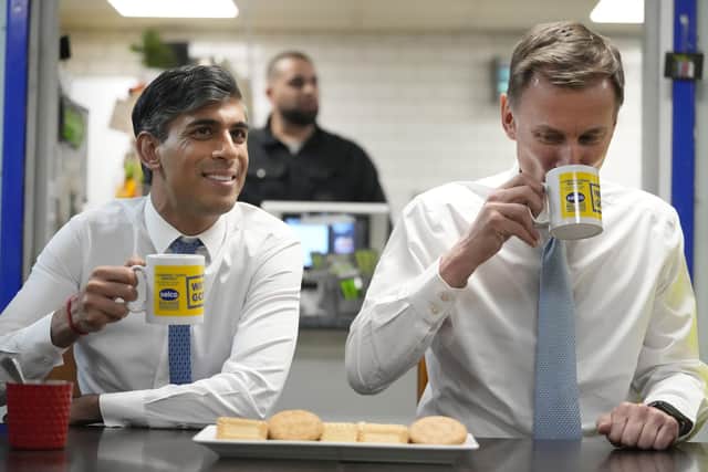 Rishi Sunak and Jeremy Hunt meet staff during a visit to a builders merchant in south east London, after the Chancellor delivered his Budget at the Houses of Parliament. Photo: Kirsty Wigglesworth/PA Wire