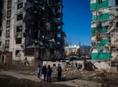 Ukrainian bystanders look on to residential buildings that were destroyed during an attack, in Borodyanka on Wednesday.