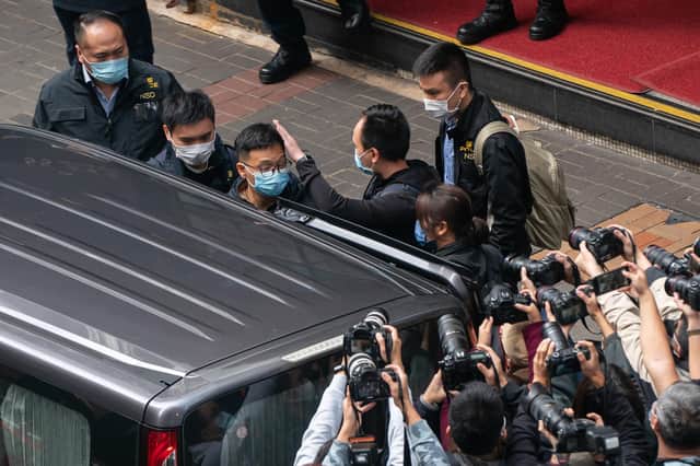Stand News editor-in-chief Patrick Lam is taken away after police searched the offices of the independent news outlet in Hong Kong (Picture: Anthony Kwan/Getty Images)