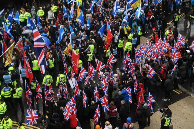 Pro-independence protesters with Scottish Saltire flags (top) march for Scottish independence. Picture: Andy Buchanan/AFP via Getty Images