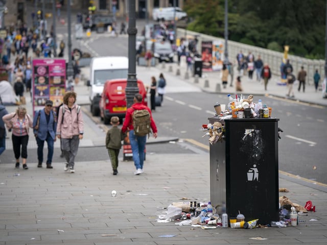 Bins and litter along Waverley Bridge in Edinburgh city centre as cleansing workers from the City of Edinburgh Council are on the fourth day of eleven days of strike action. Workers at waste and recycling depots across the city have rejected a formal pay offer of 3.5 percent from councils body Cosla. Picture date: Monday August 22, 2022.