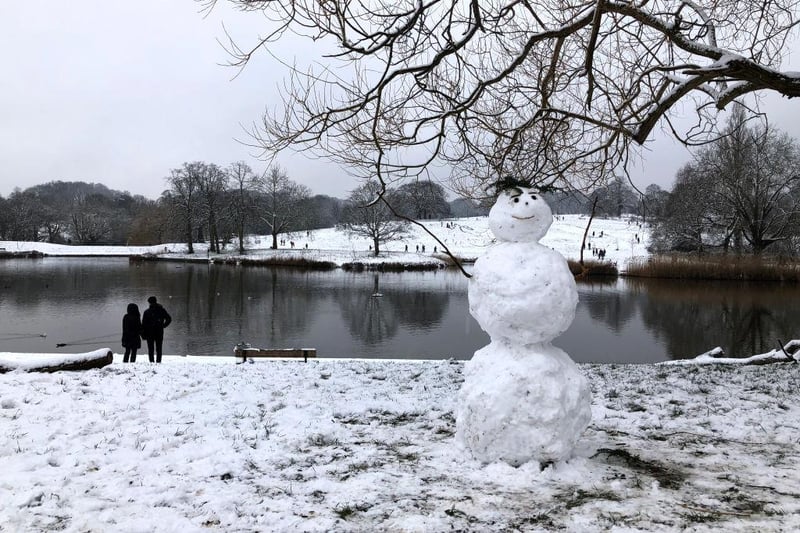 A snowman stands proud in the snow at Hampstead Heath, England.