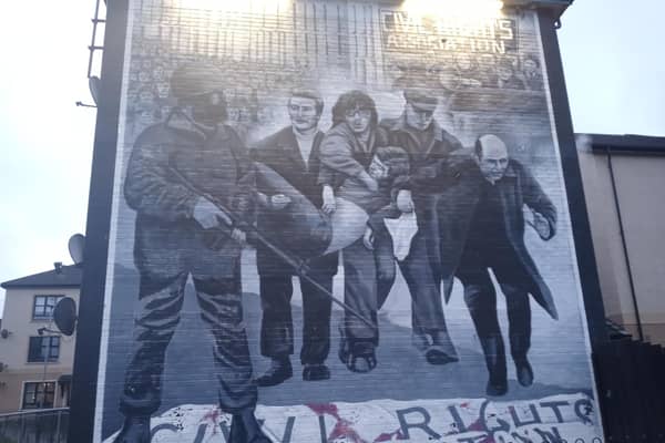 Bogside Artists' mural depicting a famous photograph from Bloody Sunday of the dying Jackie Duddy being carried by local men as a local priest Fr Edward Daly (later Bishop) tries to lead them to safety waving a blood stained white handkerchief. The mural is one of several which make up the People's Gallery in the Bogside, where the killings happened. Picture: JPIMedia