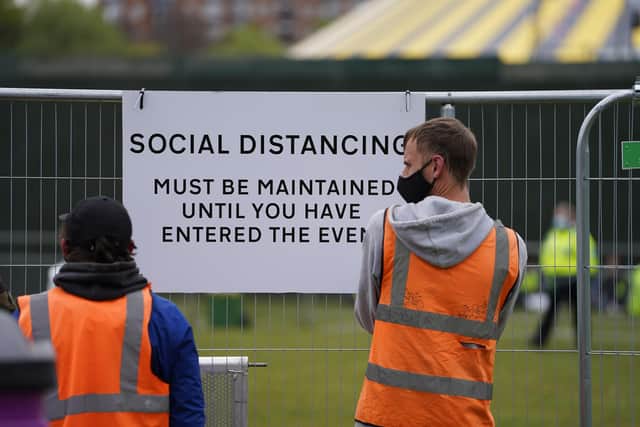 Signage being put up at a music festival in Sefton Park in Liverpool as part of the national Events Research Programme (ERP). Picture date: Sunday May 2, 2021.