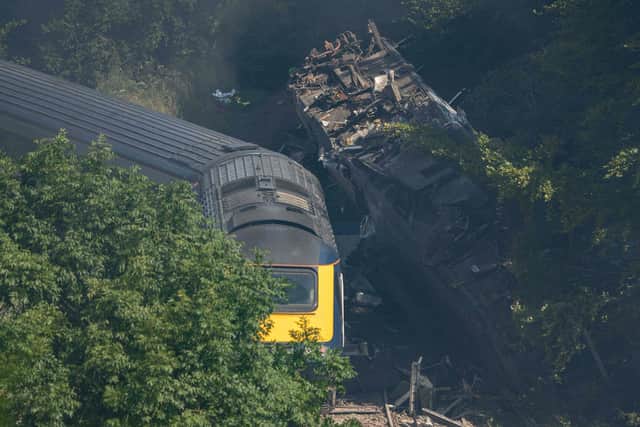Derailed carriages are seen at the scene of a train crash near Stonehaven in northeast Scotland on August 12, 2020. (Photo by MICHAL WACHUCIK/AFP via Getty Images)