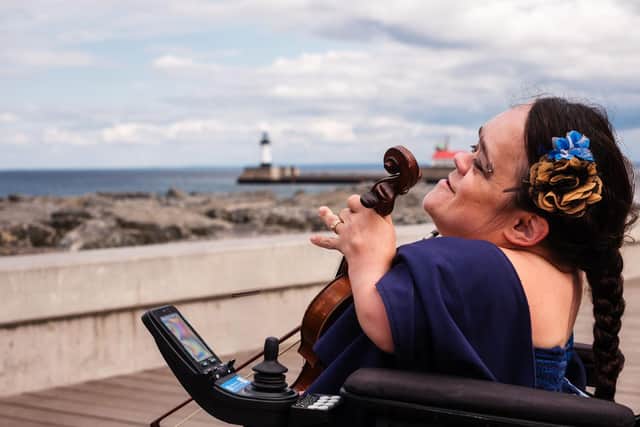 Gaelynn Lea looking out onto Lake Superior from the shore in Duluth, Minnesota.