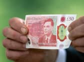 Alan Turing note enters circulation: Governor of the Bank of England Andrew Bailey poses for a photograph with the new fifty pound (GBP) note, featuring an image of mathematician and scientist Alan Turing, at Bletchley Park in Milton Keynes, on June 21, 2021. (Image credit: Joe Giddens via Getty Images)