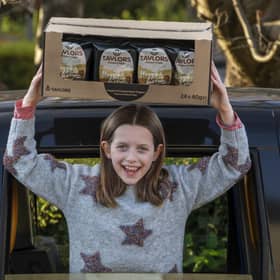 10-year-old Grace with some of her year's supply of crisps. Photo: Mike Wilkinson/Taylors Snacks/PA Wire