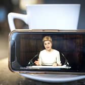 First Minister Nicola Sturgeon delivering an update statement is streamed on a smartphone during a virtual session of the Scottish Parliament