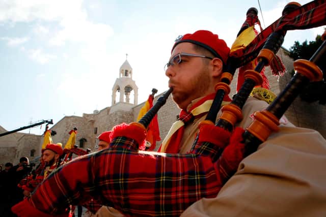 A Palestinian bagpiper plays during a performance in front of the Church of the Nativity in Bethlehem's Manger Square on Christmas Eve 2018 (Picture: Hazem Bader/AFP via Getty Images)