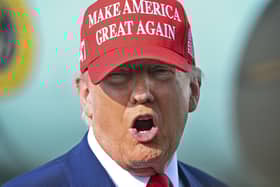 President Donald Trump speaks to reporters after landing at Palm Beach International Airport.