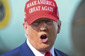 President Donald Trump speaks to reporters after landing at Palm Beach International Airport.