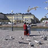 Tourists feed seagulls in front of the Presidential palace in Helsinki, Finland. The country was named the happiest nation in the world for the sixth year in a row.