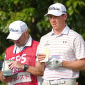 Grant Forrest checks his yardage along with caddie Dave Kenny on the sixth tee in the second round of the ISPS Handa Championship at PGM Ishioka GC in Japan. Picture: Yoshimasa Nakano/Getty Images.