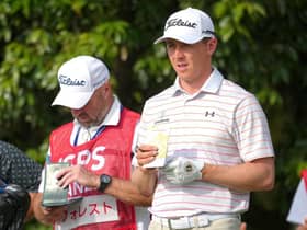 Grant Forrest checks his yardage along with caddie Dave Kenny on the sixth tee in the second round of the ISPS Handa Championship at PGM Ishioka GC in Japan. Picture: Yoshimasa Nakano/Getty Images.