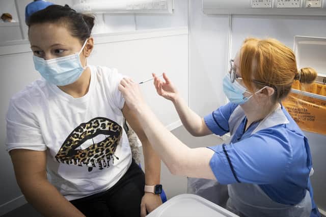 Nurse Eleanor Pinkerton administers a coronavirus vaccine to one of the health and social care staff at the NHS Louisa Jordan Hospital in Glasgow on January 23.