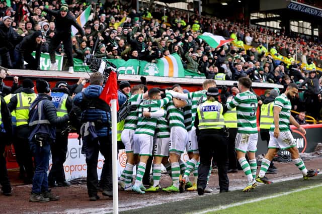 The Celtic players celebrate in front of their fans after finally breaking the deadlock against Aberdeen.