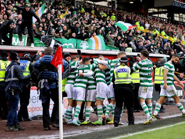 The Celtic players celebrate in front of their fans after finally breaking the deadlock against Aberdeen.
