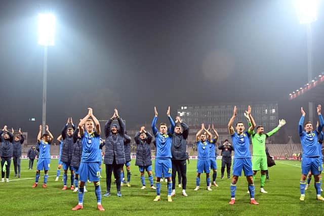 Ukraine's players celebrate their victory over Bosnia with supporters after the FIFA World Cup Qatar 2022 qualification football match in Zenica.