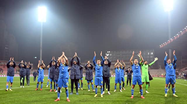 Ukraine's players celebrate their victory over Bosnia with supporters after the FIFA World Cup Qatar 2022 qualification football match in Zenica.