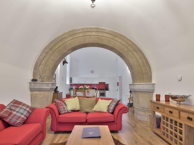 A particular highlight is the stone archway in the open plan kitchen dining living area.