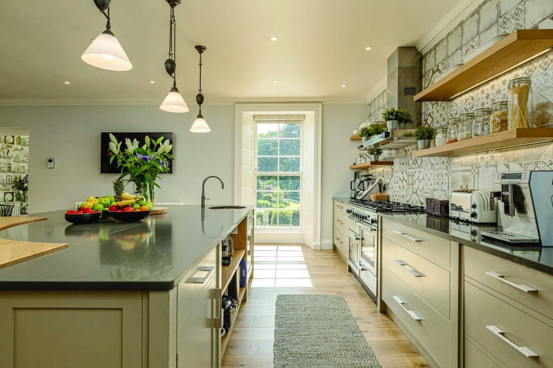 The couple introduced a family hub to the ground floor with a bespoke designer kitchen, dining space and garden room with full height windows overlooking the Water of Leith.