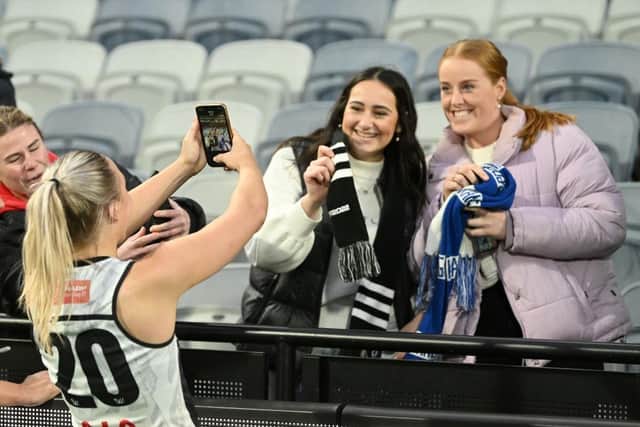Eliza James of the Magpies takes a fans BeReal following the round three AFLW match between the Geelong Cats and the Collingwood Magpies at GMHBA Stadium on September 10, 2022 in Geelong, Australia. (Photo by Morgan Hancock/AFL Photos/via Getty Images)