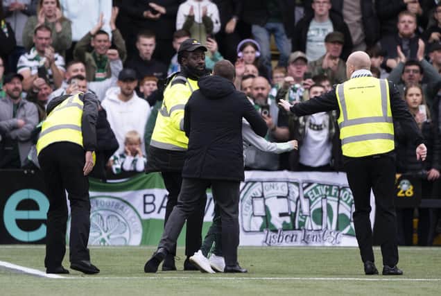Celtic manager Brendan Rodgers intervenes as a young fan is huckled by stewards. (Photo by Paul Devlin / SNS Group)