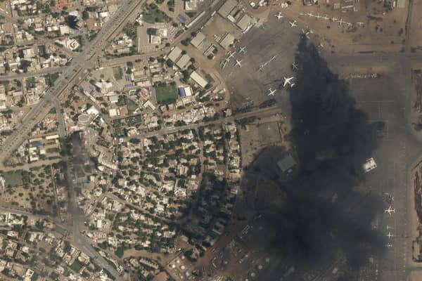 This satellite photo by Planet Labs PBC shows two burning planes at Khartoum International Airport, Sudan, Sunday April 16, 2023. The Sudanese military and a powerful paramilitary group are battling for control of the chaos-stricken nation for a second day.  The weekend’s civilian death toll rose to 97. (Planet Labs PBC via AP)