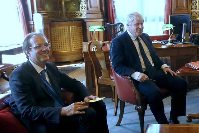 Prime Minister Boris Johnson with his principal private secretary, Martin Reynolds (left), who sent an email to more than 100 Downing Street employees asking them to "bring your own booze" for an evening gathering, ITV reported.