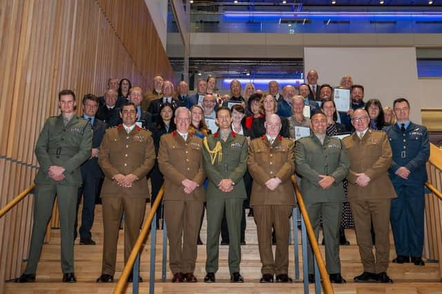 The ERS Silver Award winners are joined on the staircase of City of Glasgow College Riverside Campus by Brigadier Andy Muddiman.