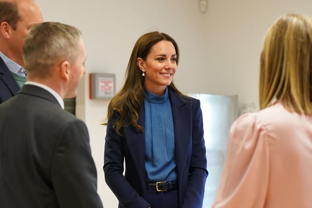 The Duchess of Cambridge talks with staff at the school.