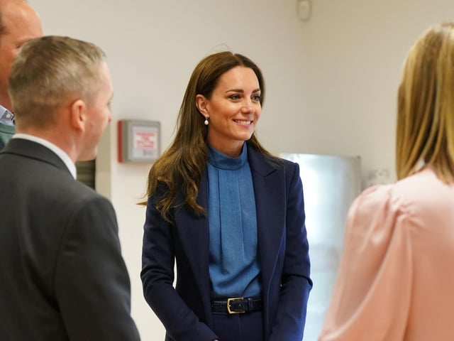 The Duchess of Cambridge talks with staff at the school.